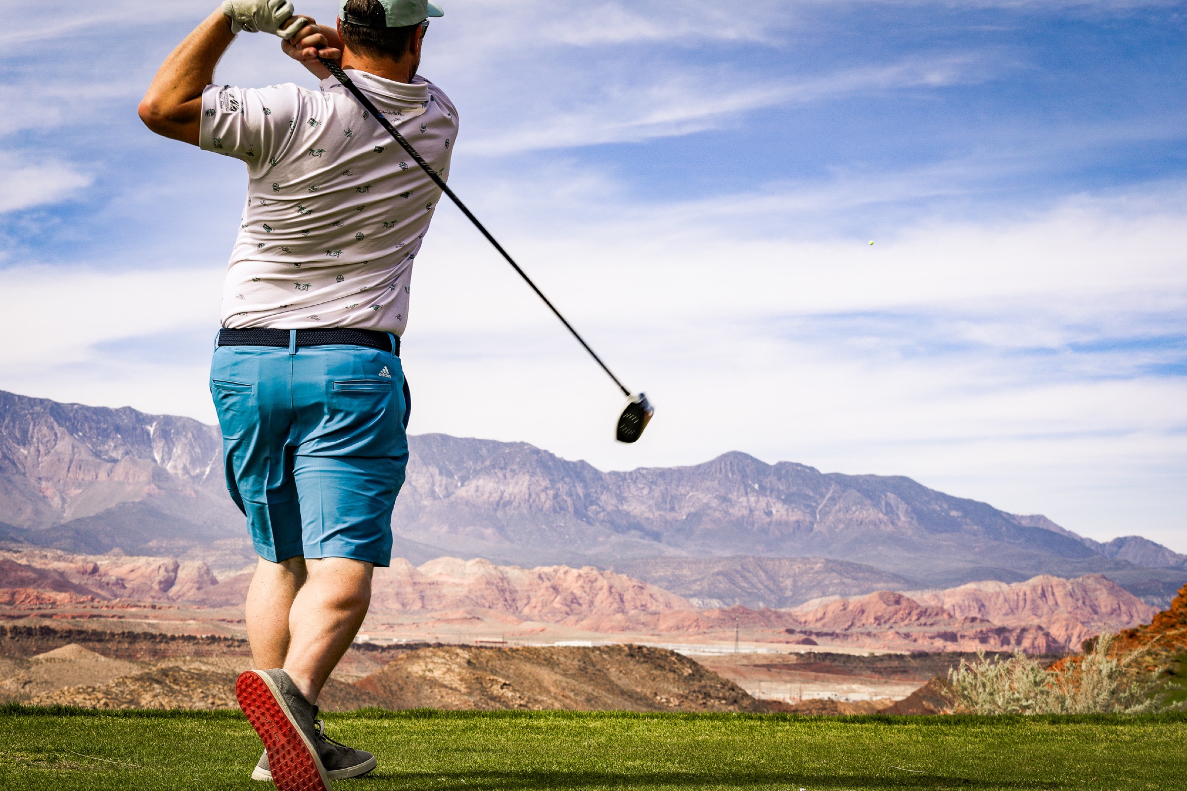 Golf swing against mountains