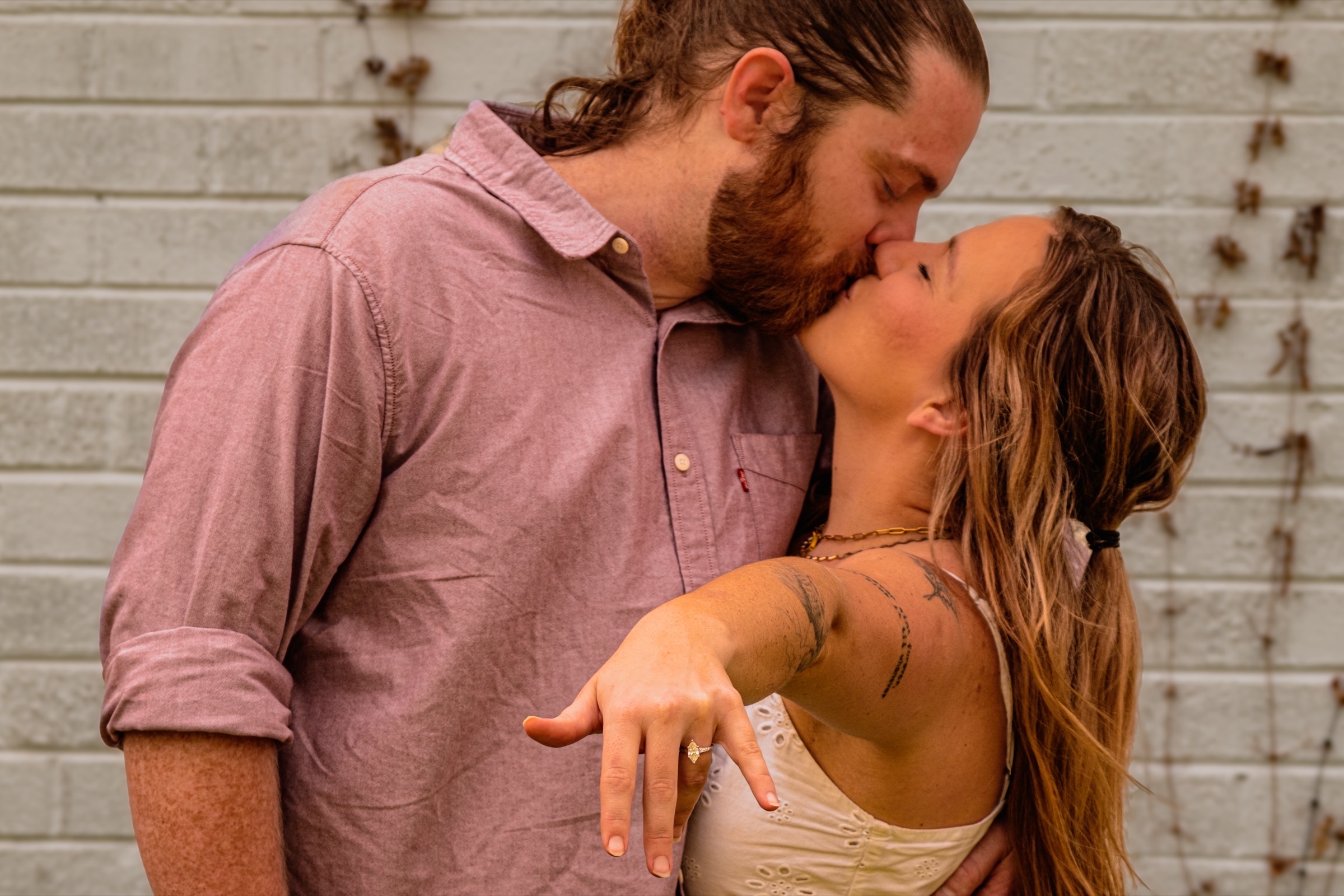 Engagement session against a brick wall in East Austin